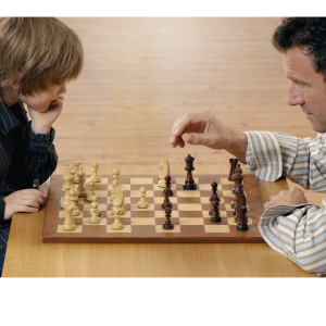 Dad and Son playing Chess